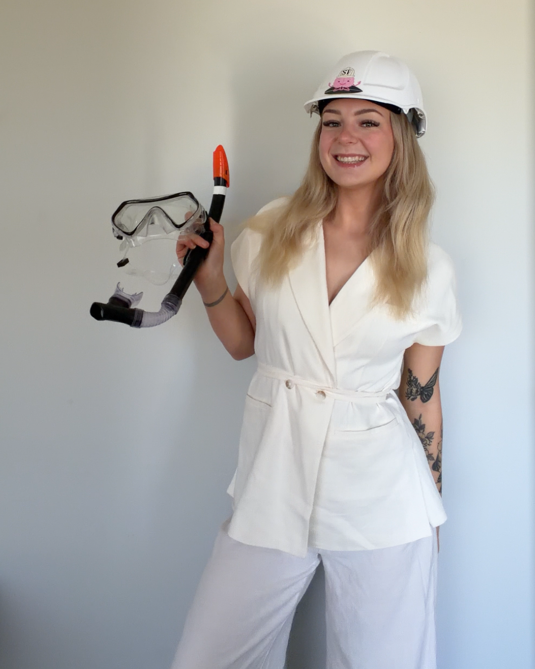 Tegan, founder of Soul Tide Foundations, wearing a hard hat and holding snorkel gear
