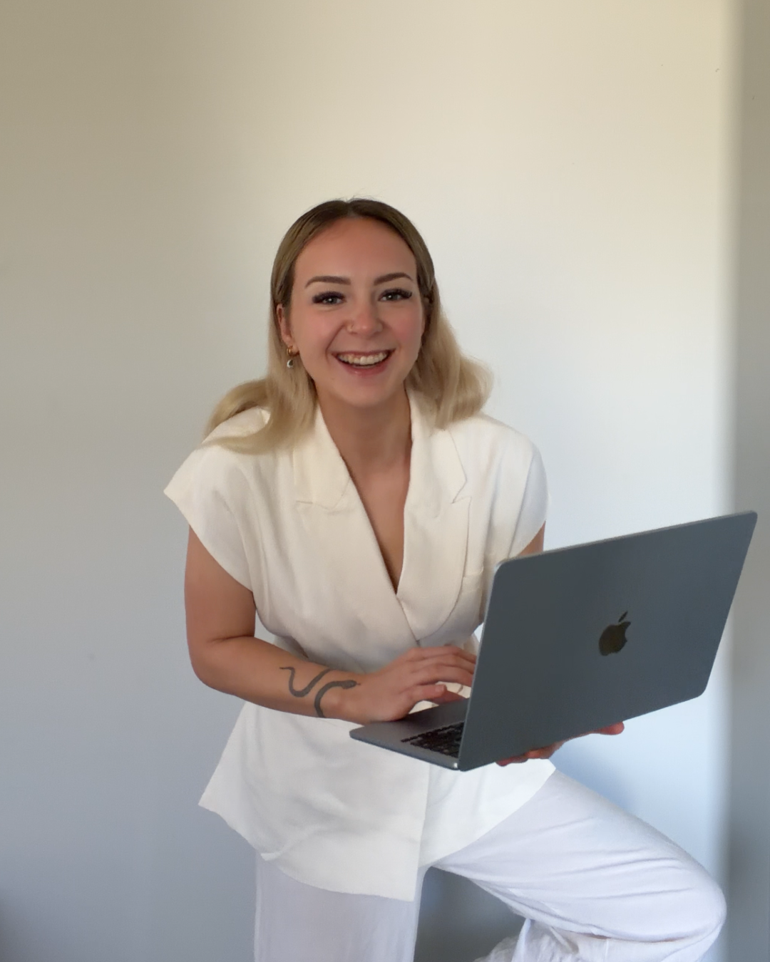 Tegan smiling with her laptop